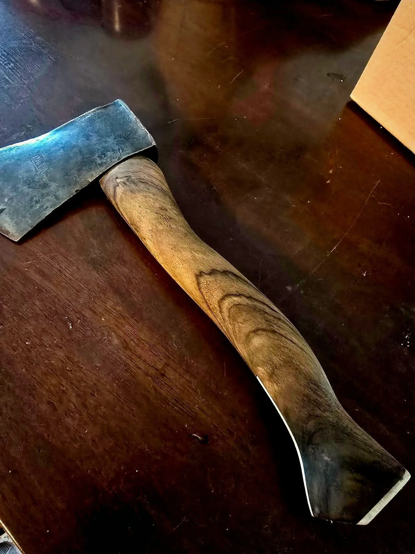 An axe resting in a salvaged timber log at the Grizzly Timber Works yard
