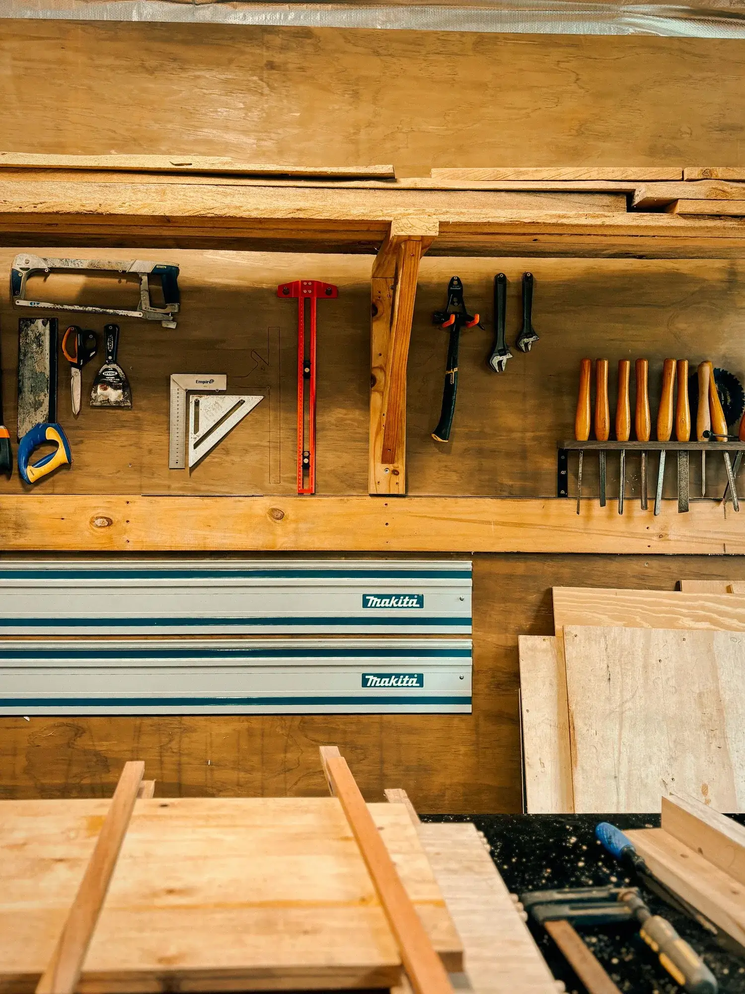 A milled timber slab on the workbench with hand tools