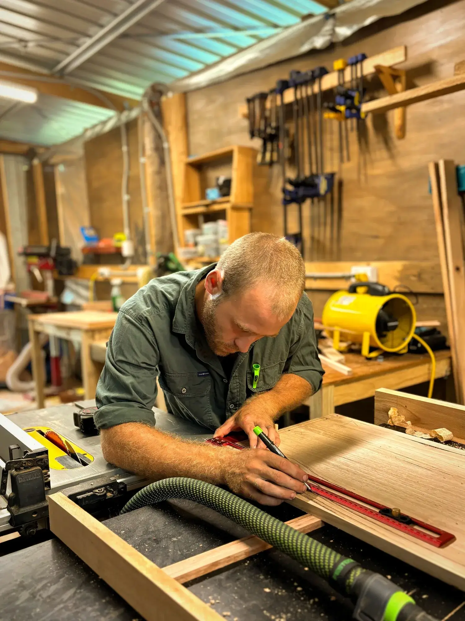 The maker shaping a timber piece at the workbench