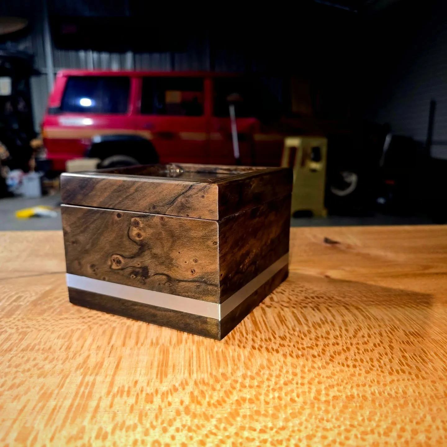 A dark timber keepsake box with a hand-finished lid