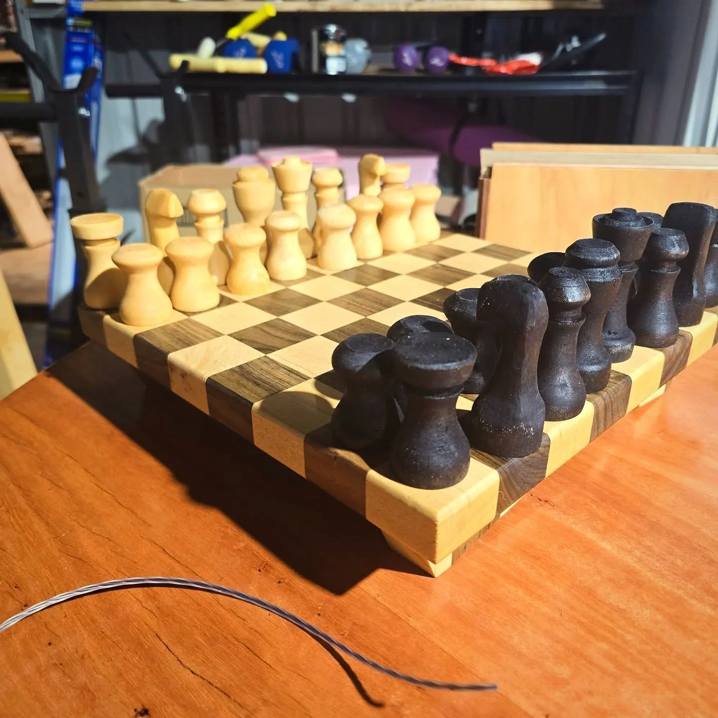 A hand-carved timber chess set on a handmade board