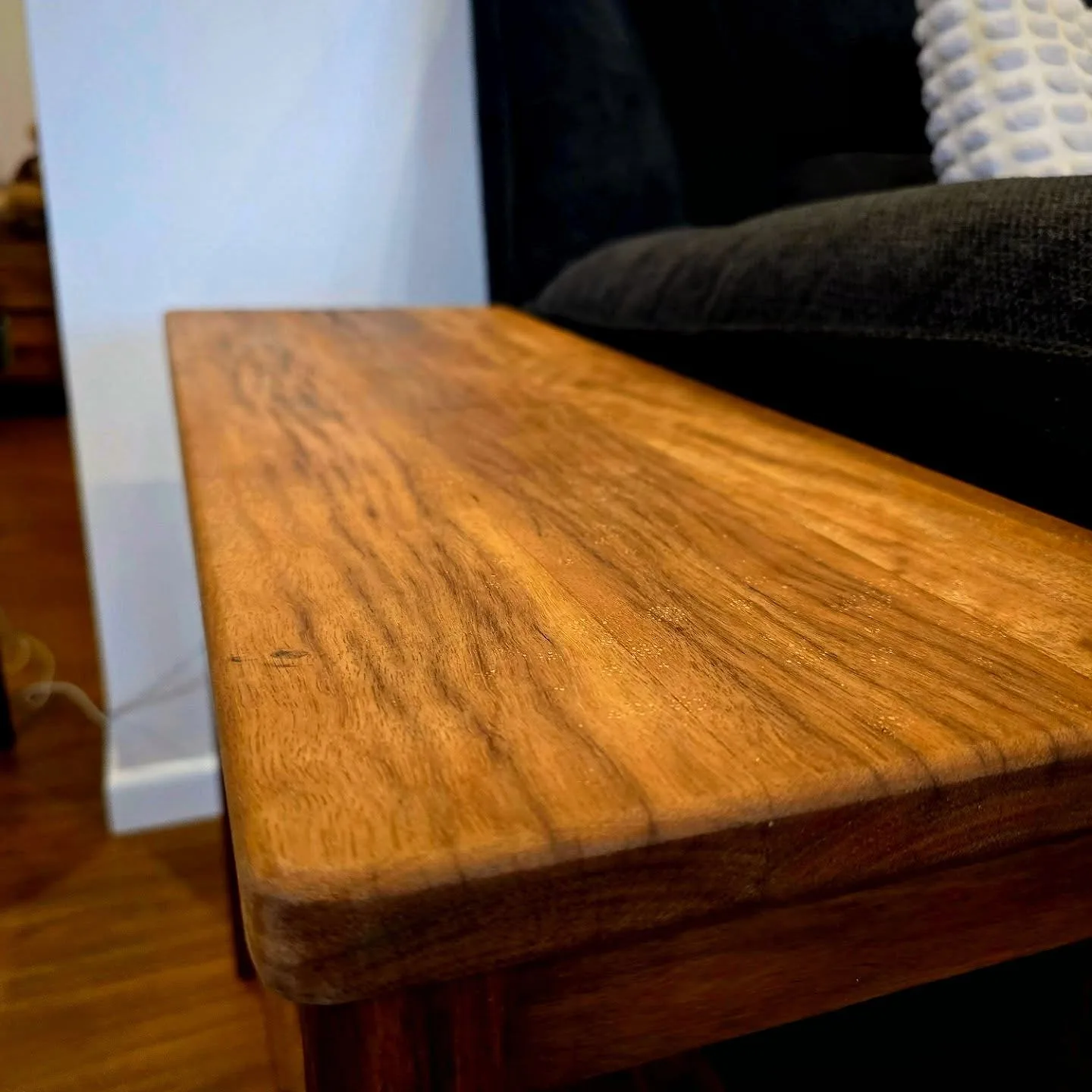 Close up of a live-edge timber surface showing natural grain