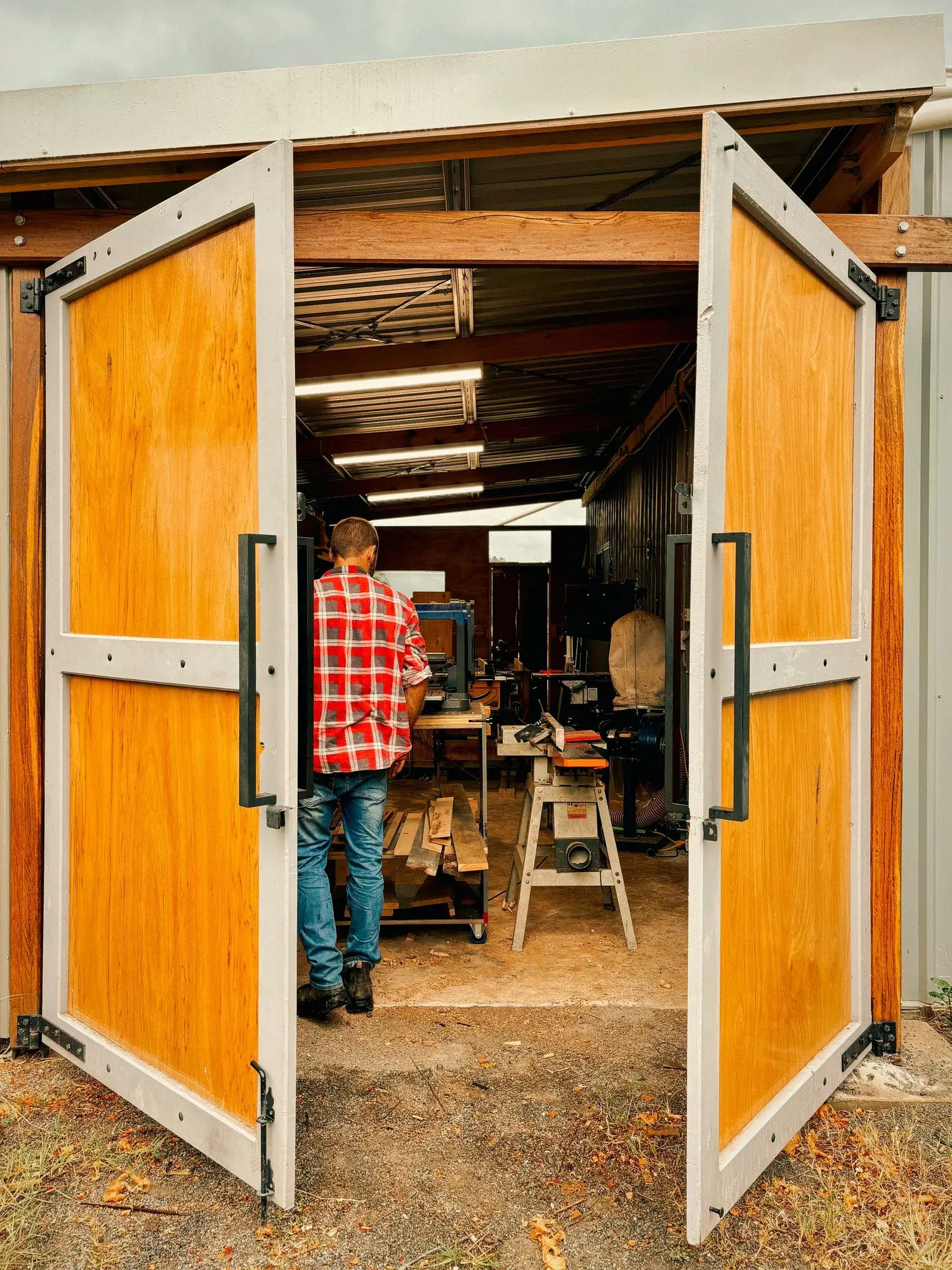 Inside the Grizzly Timber Works workshop with large timber slab doors